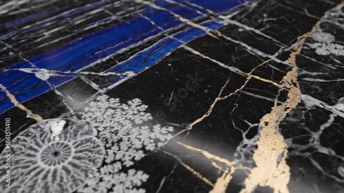 Polished black rock with blue streaks, crystalline clusters and spiral fossil