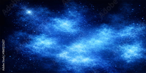 A deep blue space background features a bright galaxy nebula with glowing stars and dark cosmic clouds across the vast night universe in this fantasy astronomy illustration