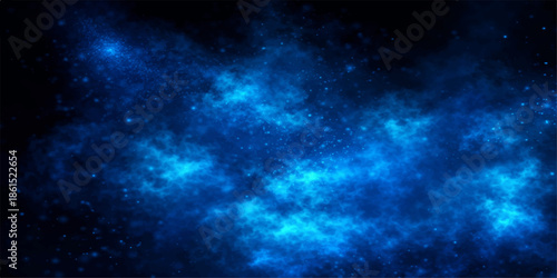 A deep blue nebula cloud drifts through a dark starry universe in this abstract space background illustration of a bright cosmic galaxy night