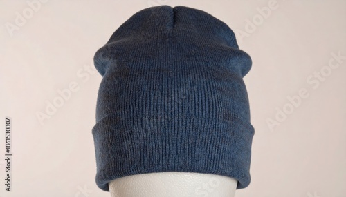 Close-up of a dark blue knitted beanie hat.