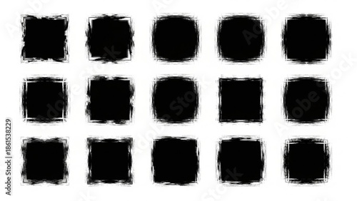 A collection of black squares with rough edges on a