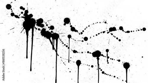 Black ink splatters and drips on creating abstract art piece