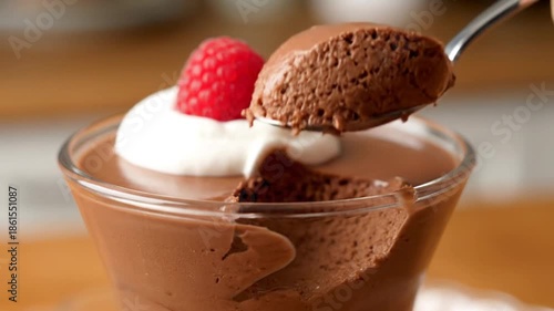 Chocolate dessert with whipped cream and raspberry garnish