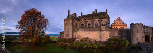 Εκτύπωση καμβά Large English oak tree with vibrant autumn leaves framing Stirling Castle, the 1