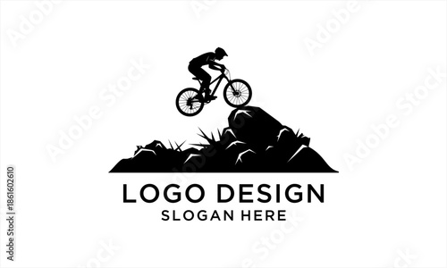 Dynamic silhouette of a mountain biker mid-air over rocky terrain, showcasing extreme sports and adventure.
