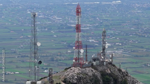 Aerial video of Skanderbeg’s Tomb Peak antennas rising above rocky cliffs with the vast Lezhë plain extending behind.