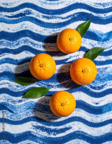 Fresh Oranges on Blue Wavy Pattern Background Flat Lay