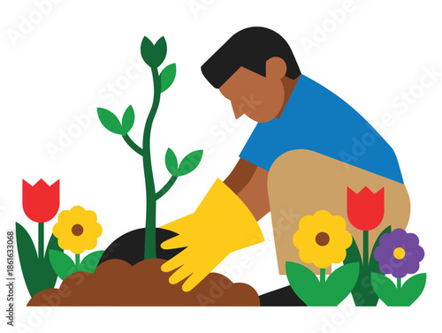 A person wearing yellow gloves plants a sapling in a garden surrounded by flowers.