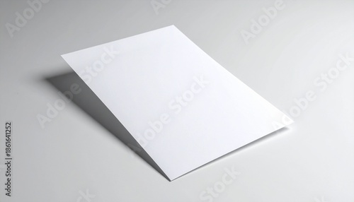 Clean blank white folded paper brochure or leaflet mockup template on a minimalist grey background. Ideal for professional design concepts, branding visuals, and marketing with ample copy space