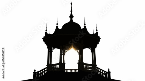 Silhouette of an ornate Victorian bandstand against a bright white sky.