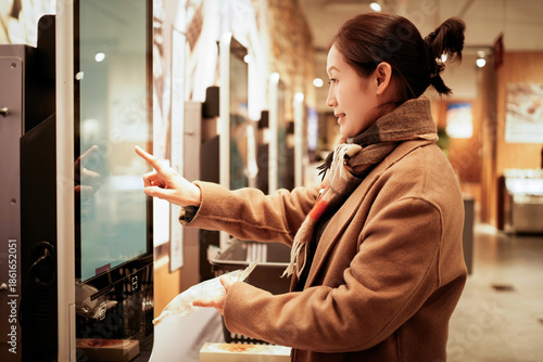 Wallpaper Mural Woman using self-service kiosk in shopping mall Torontodigital.ca
