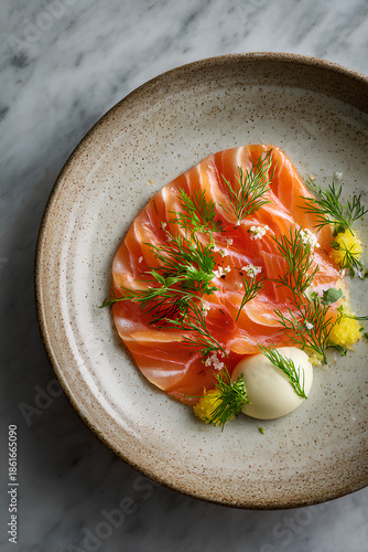 Elegant gravad lax dish with thinly sliced cured salmon marbled texture dill mustard sauce and lemon on refined ceramic plate  
