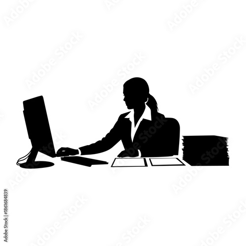 A business woman sits at an office desk typing on a laptop, a professional person utilizing modern technology and internet connectivity
