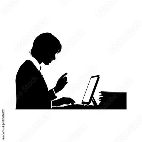Silhouette of a business person working at a desk with computer and documents.