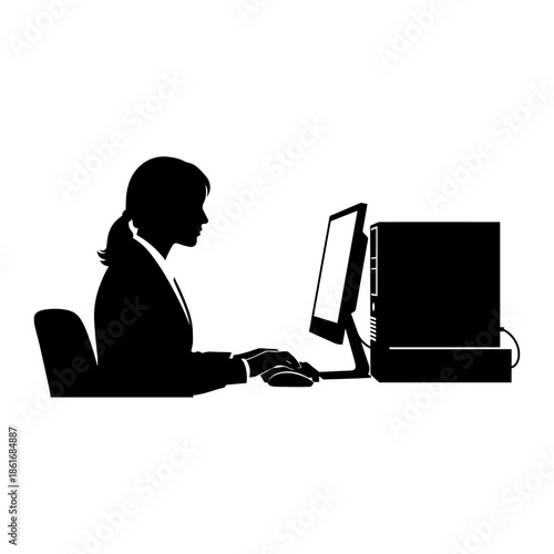 Silhouette of a businesswoman working on desktop computer at office desk.