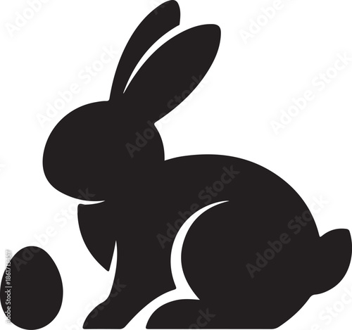 Black silhouette of a rabbit sitting next to an egg