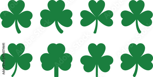 A collection of seven green four leaf clovers on a white background