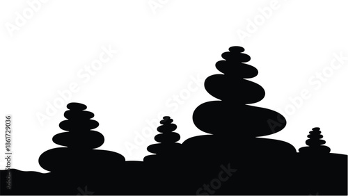 Silhouette of balanced stacked stones creating a serene and meditative landscape