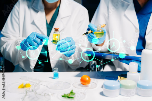 cientific skincare research with cosmetic serum, cream and natural oil extraction in laboratory.