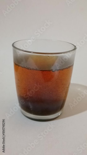 Tea Leaves Brewing in Clear Glass Cup