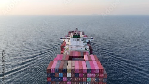 4K Back view of a large container cargo ship traveling over the ocean