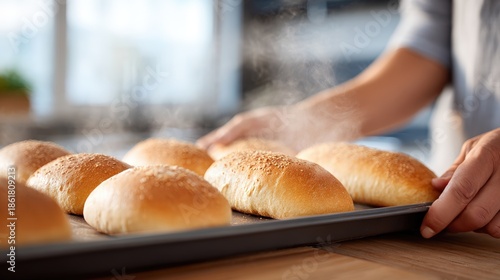 Freshly baked bread rolls being removed from the oven, showcasing golden crusts and steam rising, creating a warm and inviting atmosphere in a cozy kitchen setting