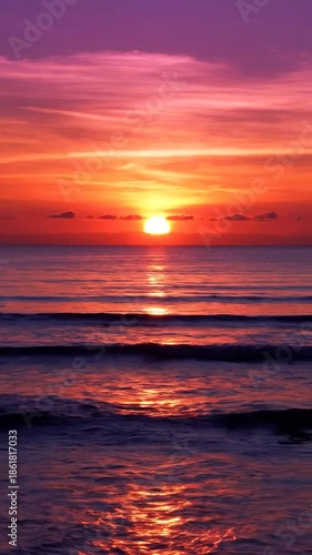 Wallpaper Mural A vertical view of a vibrant sunset over the ocean, colors from orange to purple Torontodigital.ca