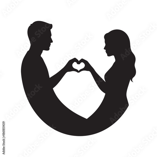 Loving couple forming heart shape with hands in silhouette