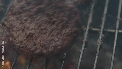Flipping over a burger patty on a griller