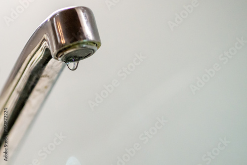 Photos Leaky faucet dripping water, close-up, shiny metal