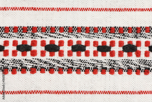 Traditional Ethnic Red and Black Geometric Embroidery Pattern on White Linen Fabric Background