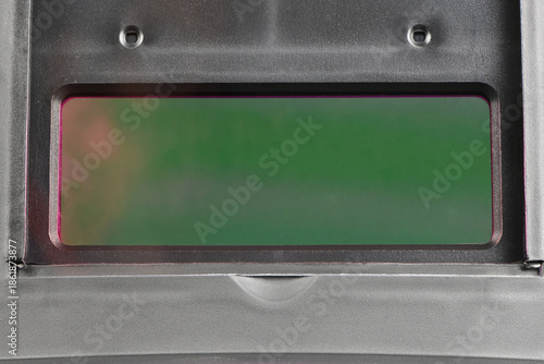 Green interior view of auto-darkening welding helmet lens