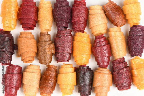 Large Background Pattern of Assorted Fruit Leather Rolls