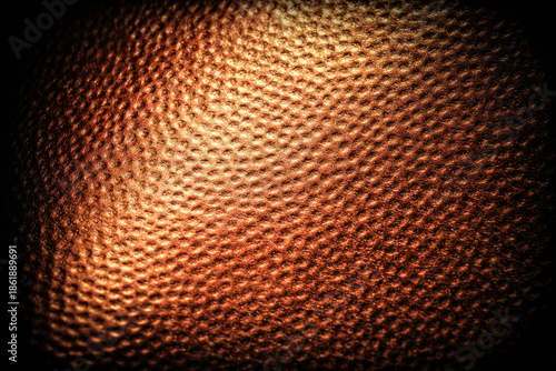 Hammered copper texture with warm metallic tones and dimpled surface pattern creates rustic and elegant background for design or craft projects