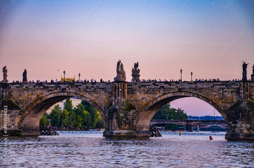 Fototapeta premium Czech Republic, Prague September 6, 2025, The Charles Bridge in Prague is undoubtedly one of the most popular bridges in Europe, and behind it, Prague Castle, towering over the Vltava River