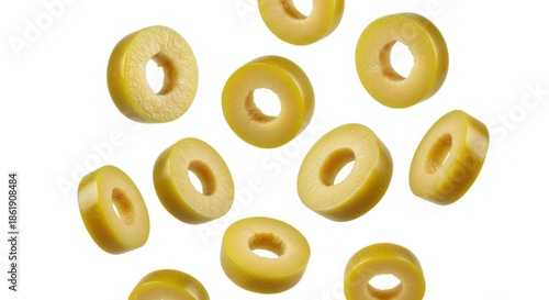Sliced green olives in motion against a white background, perfect for food content.