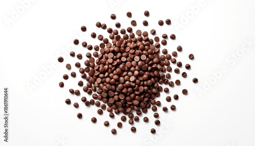 A pile of brown seeds or grains scattered on a white surface, possibly for cooking or planting.