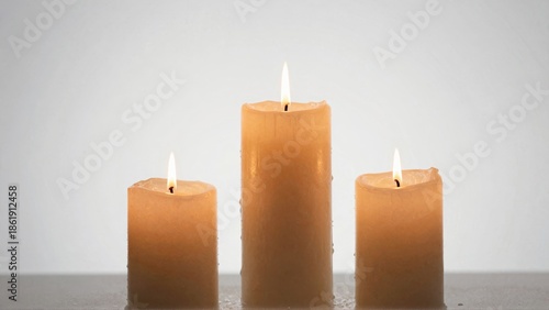 Wallpaper Mural Three lit candles on plain surface Torontodigital.ca