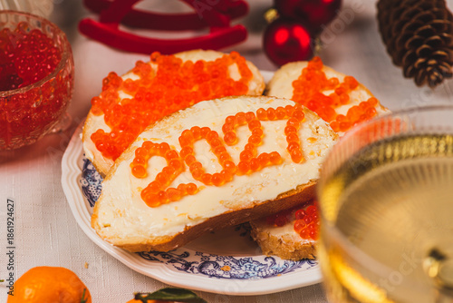 A sandwich with butter and caviar. The figures for 2027 are laid out in dots.