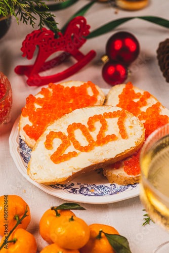 A sandwich with butter and caviar. The figures for 2027 are laid out in dots.