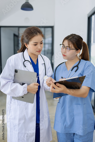 Two asian female doctor with clipboard in modern clinic, Doctor woman and medical coat working in hospital.