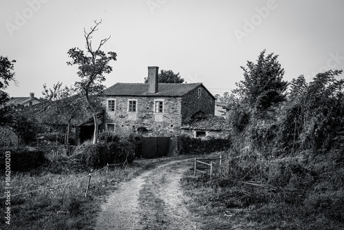 Traditional rural stone house with wooden gallery and slate roof