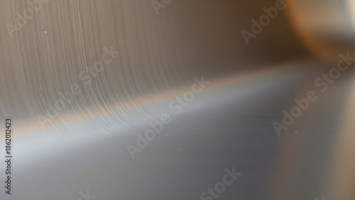 couter. Metal surface transitioning from rough matte to glossy finish with light reflections. safety posters, maintenance manuals, designed for precision metalworking and fabrication facilities.