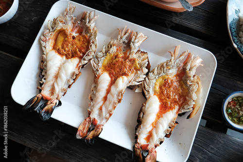 Grilled giant prawn and cutting half shrimp served on a white plate famous in Thai seafood.