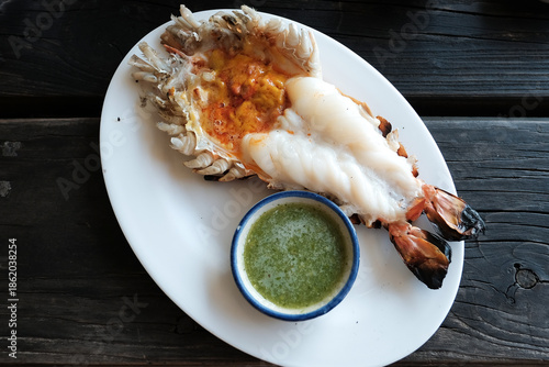 Grilled giant prawn and cutting half shrimp served on a white plate famous in Thai seafood.