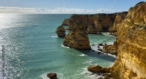 Praia da Marinha, beautiful beach Marinha in Algarve, Portugal. Navy Beach (Praia da Marinha) with flying seagulls over the beach, located on the Atlantic coast in Lagoa Municipality, Algarve.