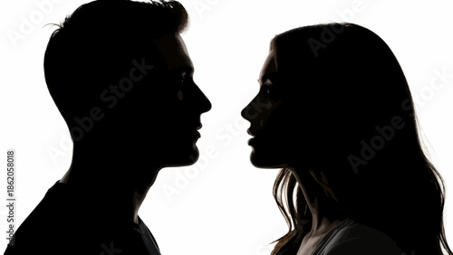 A romantic couple stands face to face in a dramatic silhouette against a bright background