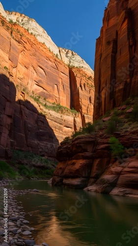 Canyon landscape with river flowing through red rock formations.