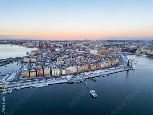 Photography Amazing aerial view of Stockholm old town at dawn, with snow on the buildings, a
