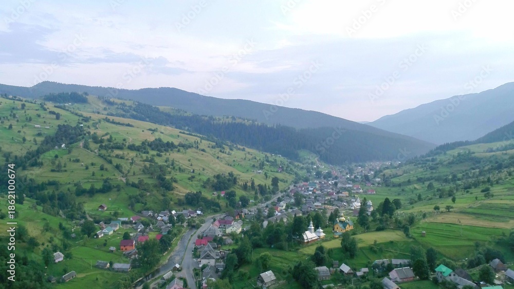 Fototapeta premium Mountain village with cute lovely houses in valley